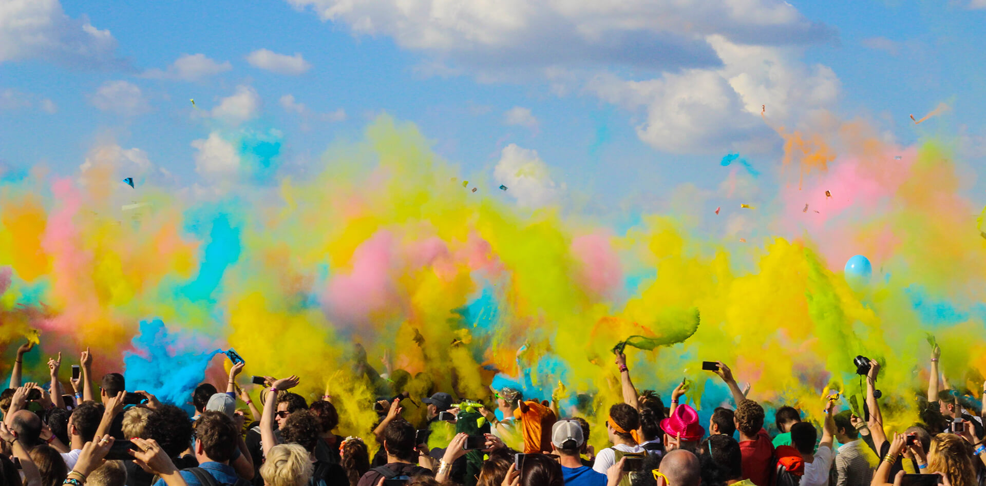 crowd of people at an event with color bombs.