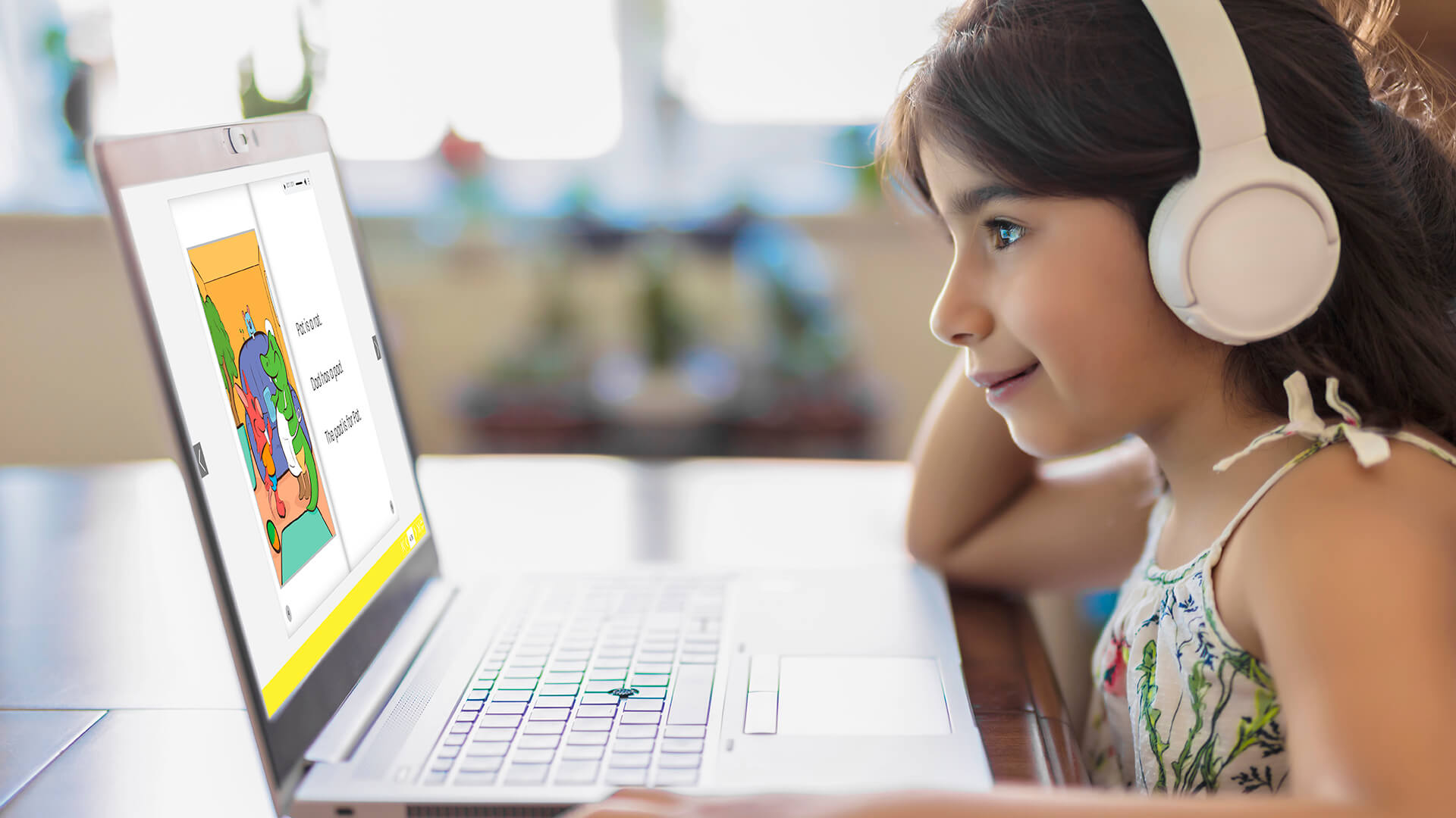 a girl reading phunics flipbook on her laptop.