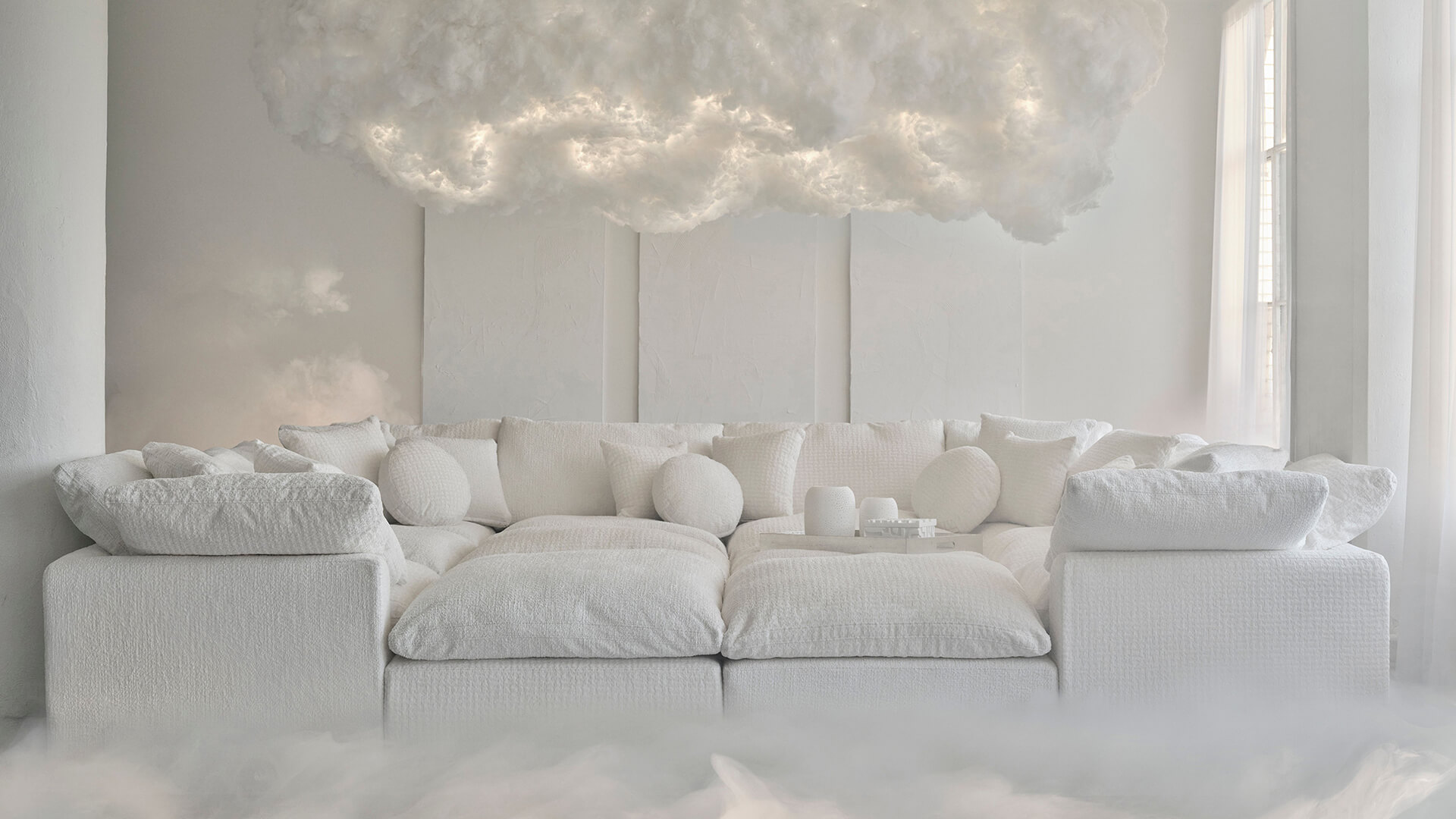 luxurious white sofa with plush cushions set in a serene room representing cloud dancer.